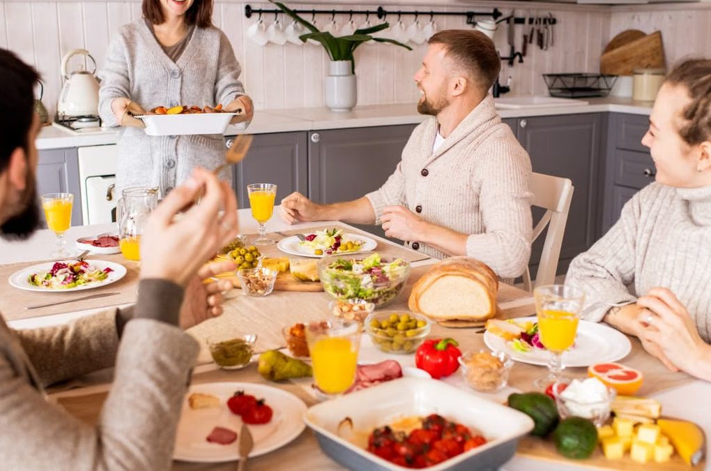 Group of friends enjoying a vibrant meal indoors, sharing laughter and good food.